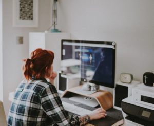 Woman with red hair working from home