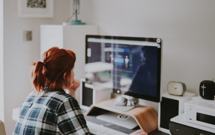 Woman with red hair working from home