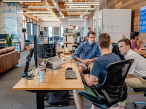 Men sitting at desk in conversation